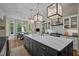 Modern kitchen island with marble counters, stainless appliances and views of the dining area at 32430 Archdale, Chapel Hill, NC 27517