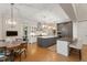 Bright kitchen with a large island and stainless steel appliances open to the dining area at 32430 Archdale, Chapel Hill, NC 27517