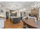 Modern kitchen with island and stainless appliances open to the bright living room with fireplace at 32430 Archdale, Chapel Hill, NC 27517