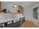 Charming kitchenette featuring farmhouse sink, marble countertops, wood floors, and ample natural light at 32430 Archdale, Chapel Hill, NC 27517