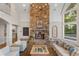 Cozy living room features a stone fireplace, hardwood floors, and a neutral color palette at 32430 Archdale, Chapel Hill, NC 27517