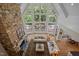 High angle view of the living room boasting stone fireplace, hardwood floors, and large windows at 32430 Archdale, Chapel Hill, NC 27517