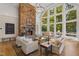 Bright living room with stone fireplace, hardwood floors, and large windows with natural light and view at 32430 Archdale, Chapel Hill, NC 27517