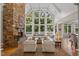 Bright and spacious living room with vaulted ceilings, a stone fireplace, and expansive windows offering scenic views at 32430 Archdale, Chapel Hill, NC 27517