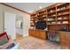 Inviting living room with custom wood built-ins, desk space, and an open doorway at 32430 Archdale, Chapel Hill, NC 27517