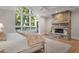 Inviting main bedroom featuring large windows, a stone fireplace and natural light at 32430 Archdale, Chapel Hill, NC 27517