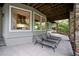 Relaxing covered patio featuring lounge chairs and views into the wooded backyard at 32430 Archdale, Chapel Hill, NC 27517