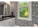 Stylish powder room featuring black and white wallpaper and a sleek vanity with a modern mirror, offering a sophisticated design at 32430 Archdale, Chapel Hill, NC 27517