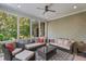 Relaxing sunroom features tile flooring, ceiling fan, and wooded views to enjoy the outdoors at 32430 Archdale, Chapel Hill, NC 27517