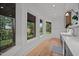 Bright sunroom with wood floors, shiplap walls, and large windows offering picturesque outdoor views at 32430 Archdale, Chapel Hill, NC 27517