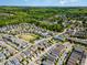 Expansive aerial view of a residential community surrounded by lush green trees and blue skies at 379 Tobacco Farm Way, Chapel Hill, NC 27516