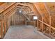 Spacious unfinished attic with exposed beams and a small window at 379 Tobacco Farm Way, Chapel Hill, NC 27516