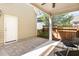 Covered back patio with brick flooring, ceiling fan, and comfortable seating area at 379 Tobacco Farm Way, Chapel Hill, NC 27516