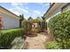 Landscaped backyard featuring a charming wooden gate and stone pathway at 379 Tobacco Farm Way, Chapel Hill, NC 27516