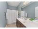 Well-maintained bathroom featuring a single sink vanity, a toilet, and a shower with curtain, complemented by neutral tones at 379 Tobacco Farm Way, Chapel Hill, NC 27516
