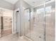 Spacious shower with tile surround, glass door, and a built-in bench, complemented by a window for natural light at 379 Tobacco Farm Way, Chapel Hill, NC 27516
