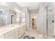 Well-lit bathroom featuring double sinks, walk-in glass shower, neutral tile flooring, and ample storage space at 379 Tobacco Farm Way, Chapel Hill, NC 27516