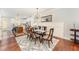 Dining area with stylish chandelier, table set for six, and an open view into the kitchen and living spaces at 379 Tobacco Farm Way, Chapel Hill, NC 27516