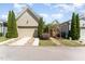 Charming home exterior with a well-manicured yard, wooden gate, and attached garage at 379 Tobacco Farm Way, Chapel Hill, NC 27516