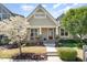 Charming home featuring a craftsman-style front porch, neat landscaping, and a blossoming tree at 379 Tobacco Farm Way, Chapel Hill, NC 27516
