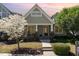 Inviting front exterior featuring a blooming tree, and landscaped yard at 379 Tobacco Farm Way, Chapel Hill, NC 27516