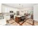 Bright kitchen featuring white cabinets, stainless steel appliances, and a center island at 379 Tobacco Farm Way, Chapel Hill, NC 27516