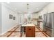 Well-lit kitchen with a center island, stainless steel appliances, and ample counter space at 379 Tobacco Farm Way, Chapel Hill, NC 27516