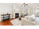 Bright living room featuring a fireplace, hardwood floors, and a neutral color palette at 379 Tobacco Farm Way, Chapel Hill, NC 27516