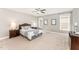 Serene bedroom featuring neutral tones, ample natural light from the double windows, and plush carpet flooring at 379 Tobacco Farm Way, Chapel Hill, NC 27516