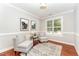 Cozy sitting room with natural light, two chairs, and hardwood floors at 379 Tobacco Farm Way, Chapel Hill, NC 27516