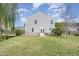 Spacious backyard features mature trees, a lush lawn, and partial fencing for privacy at 411 Lawton Dr, Haw River, NC 27258