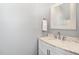 Elegant bathroom with a marble countertop vanity, modern faucet, and a decorative framed mirror at 411 Lawton Dr, Haw River, NC 27258