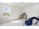 Cozy bedroom featuring large window, neutral carpet, and corner desk with sofa and throw at 411 Lawton Dr, Haw River, NC 27258