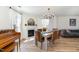 Bright dining area featuring wood floors, a chandelier, and a fireplace, seamlessly connecting to the living space at 411 Lawton Dr, Haw River, NC 27258