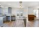 Open kitchen area with gray cabinets, stainless steel appliances, and a breakfast bar for casual dining at 411 Lawton Dr, Haw River, NC 27258