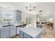 Bright and airy kitchen featuring modern appliances, a center island, and an open layout to the dining area at 411 Lawton Dr, Haw River, NC 27258
