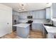 Beautiful kitchen featuring stainless steel appliances, marble countertops, and a stylish center island at 411 Lawton Dr, Haw River, NC 27258