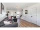 Cozy living room with wood floors, wainscoting, and comfortable seating for relaxing or entertaining guests at 411 Lawton Dr, Haw River, NC 27258