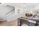 Inviting living room featuring stairs, wood floors, and an open layout leading to the dining area at 411 Lawton Dr, Haw River, NC 27258