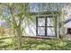 Backyard view of a storage shed with black trim, under the lush canopy of a weeping willow tree at 411 Lawton Dr, Haw River, NC 27258