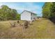 Backyard features a firepit with seating and a well-maintained lawn near the back of the house at 4228 Nc 42 Hwy, Raleigh, NC 27603
