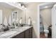 Bathroom with dual sinks, granite countertops, and a shower with blue accents at 4228 Nc 42 Hwy, Raleigh, NC 27603