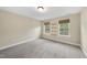 This bright bedroom features carpeted floors and a pair of windows allowing natural light at 4228 Nc 42 Hwy, Raleigh, NC 27603