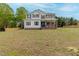 Charming two-story home with a covered porch, classic colors, and a spacious front yard at 4228 Nc 42 Hwy, Raleigh, NC 27603