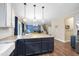 Spacious kitchen island with dark blue cabinets, granite countertop, and pendant lighting at 4228 Nc 42 Hwy, Raleigh, NC 27603