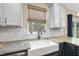 Modern kitchen featuring a farmhouse sink, granite countertops, and a window with a backyard view at 4228 Nc 42 Hwy, Raleigh, NC 27603