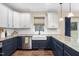 Stylish kitchen with a farmhouse sink, white cabinets, and blue lower cabinets at 4228 Nc 42 Hwy, Raleigh, NC 27603