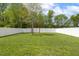 Spacious backyard with green grass, a swing set, and a white privacy fence surrounding the property at 4817 Quarryman Rd, Raleigh, NC 27610