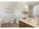 Elegant bathroom with a vanity, toilet, shower, and decorative flowers, offering a relaxing and functional space at 4817 Quarryman Rd, Raleigh, NC 27610