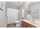 Cozy bathroom featuring a shower with a white curtain and a vanity with decorative vases at 4817 Quarryman Rd, Raleigh, NC 27610